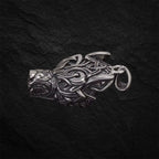 Silberner Wikinger-Wolfskopf-Anhänger seitlich fotografiert auf schwarzem Hintergrund